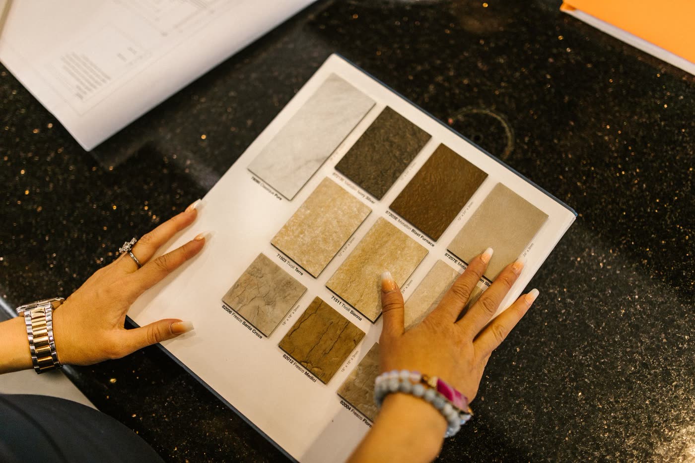 Someone comparing stone samples side by side