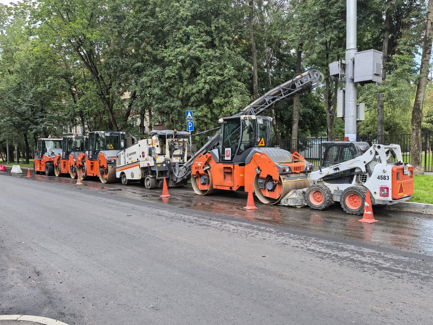 Heavy road-construction machinery lined up on a street