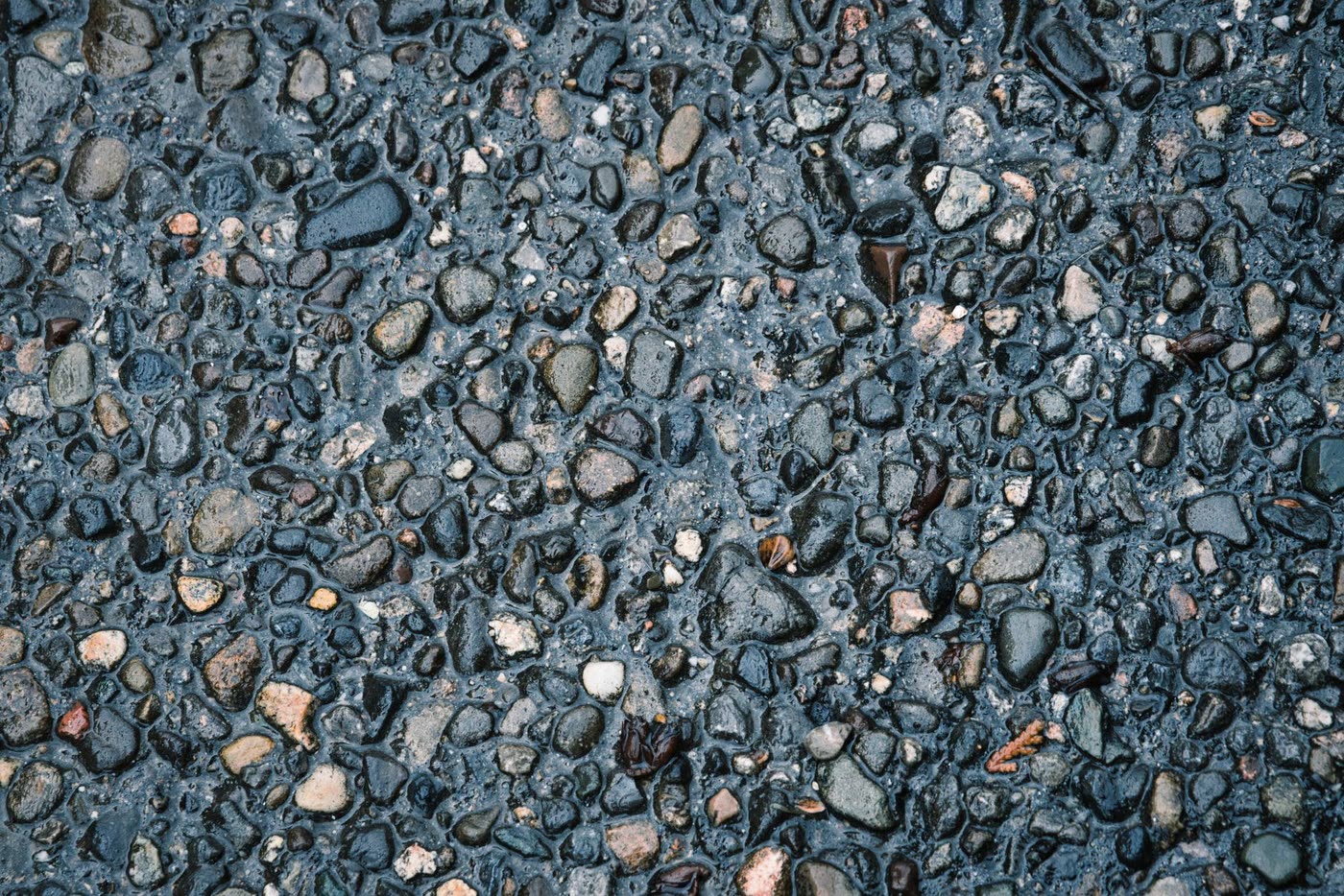 Close-up of a bound aggregate surface, wet, showing the individual stones